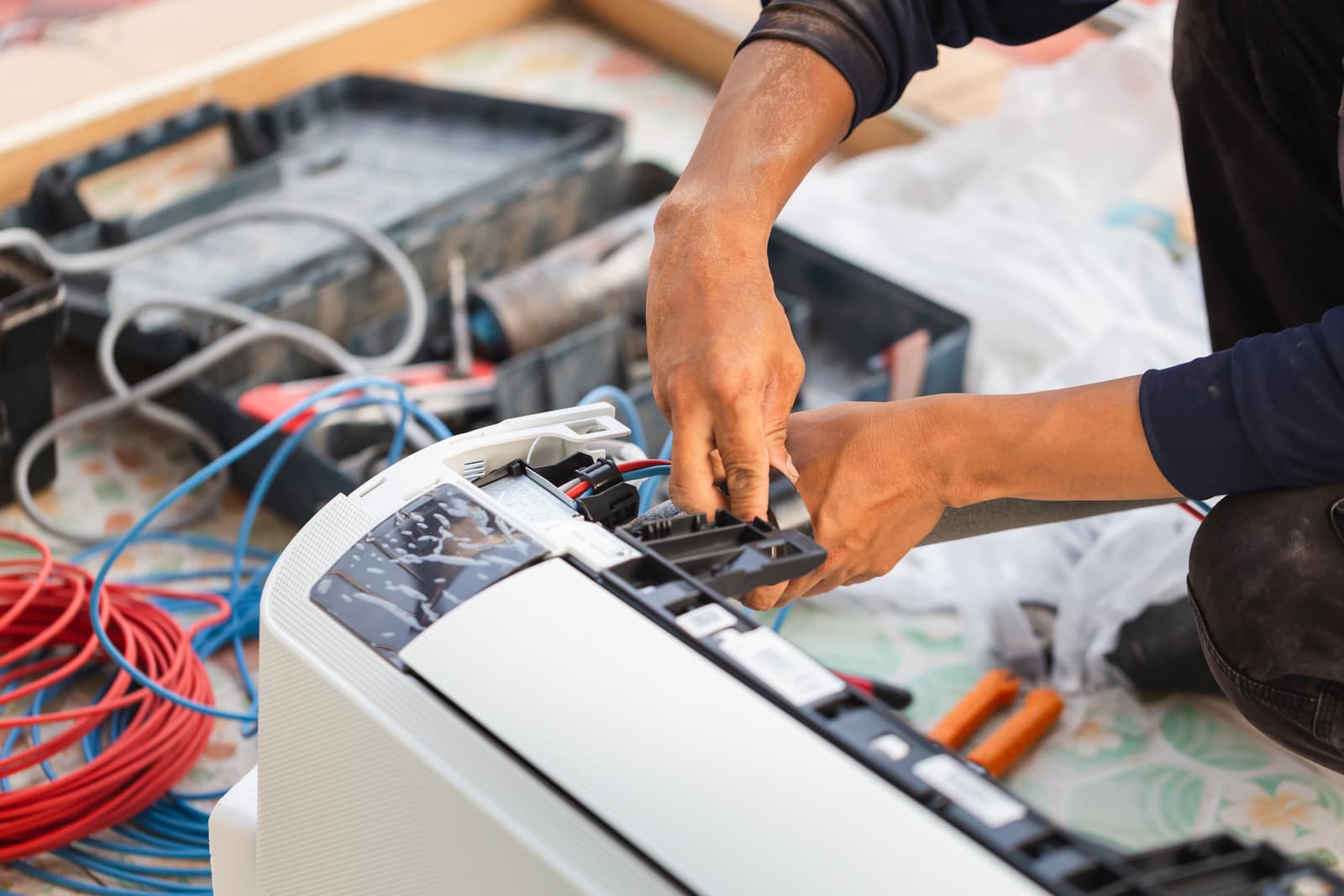 Technician repairing an aircon unit