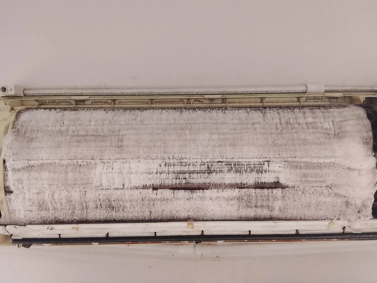 Indoor aircon coil completely covered in a thick grey dust layer