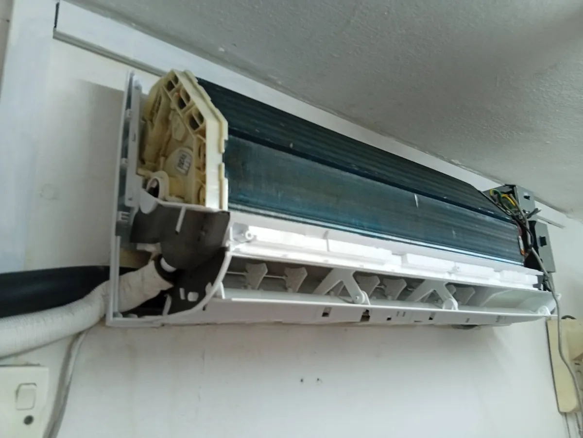 The same aircon with a new white drain pan tray fitted